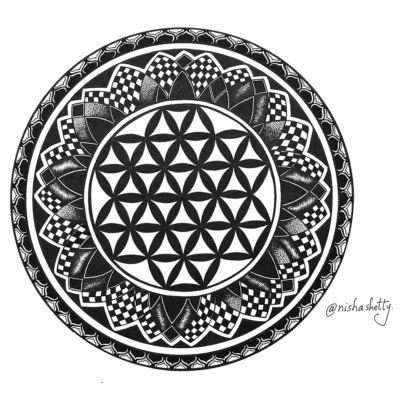 Handmade black and white mandala art created with sharpie, featuring intricate patterns and designs.