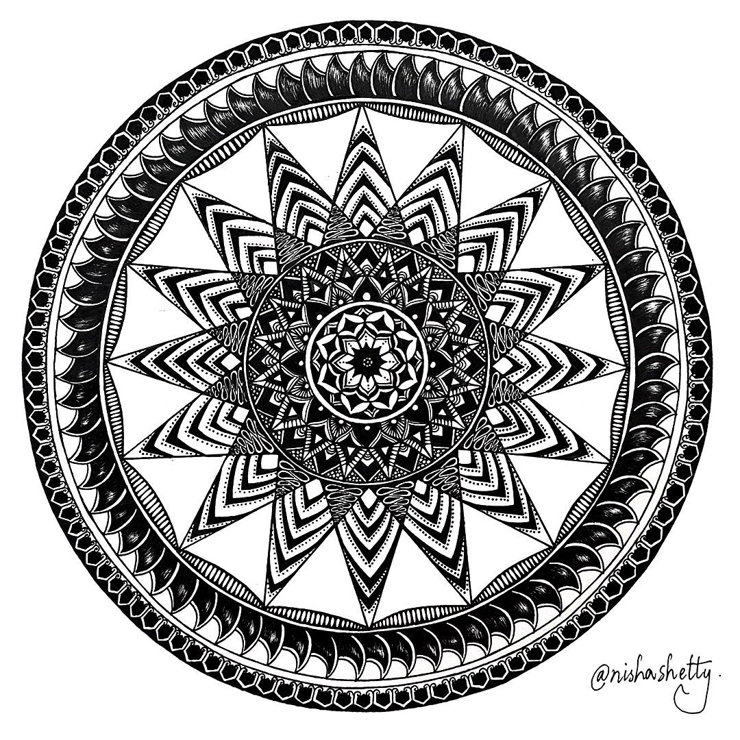 Hand-drawn black and white Sharpie mandala art by Nisha Shetty at ArtyliciouzOfficial, showcasing intricate geometric patterns. The artwork features multiple layers of circles filled with different patterns including zigzags, dots, lines, and floral shapes, radiating from a central star-like pattern mandala.